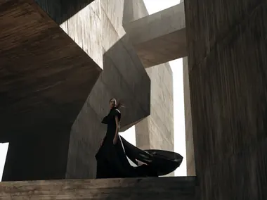 A gown photographed in a brutalist hall